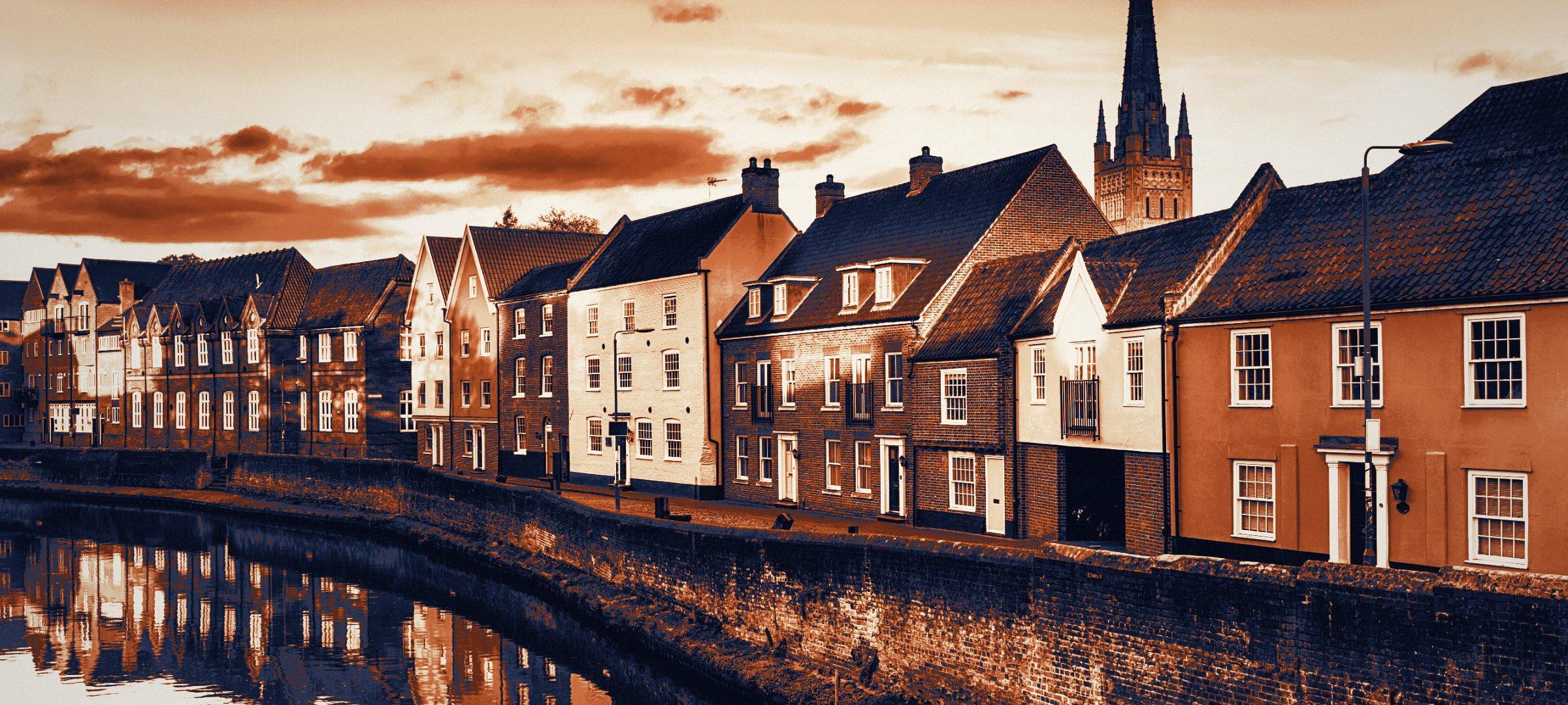 Norwich quayside with the cathedral spire above the River Wensum.